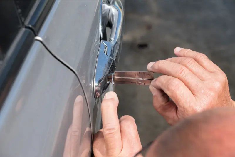 man opening car door using expert tools